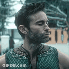 Man With Beard In Green Vest Looking Sideways GIF