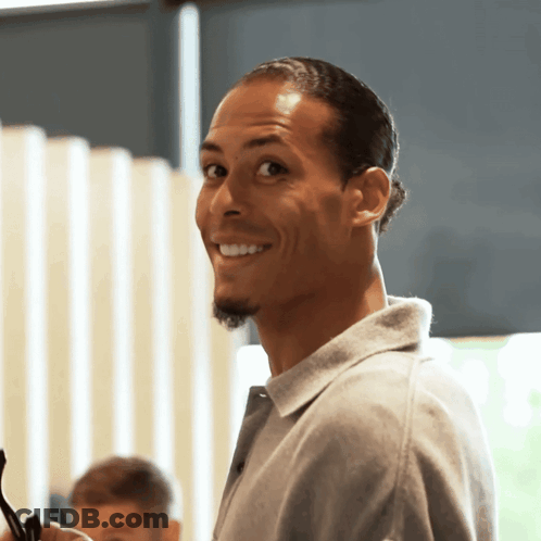 Man With Beard In Grey Shirt Smiles GIF