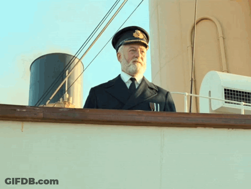 Man With Beard In Hat And Tie On Boat GIF
