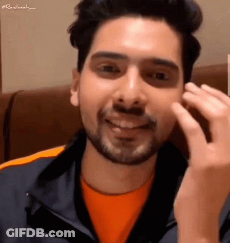 Man With Beard In Orange Shirt And Blue Jacket GIF