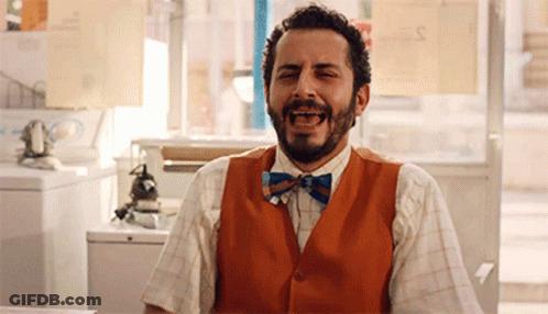 Man With Beard In Orange Vest And Bow Tie Laughing GIF