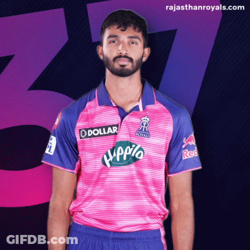 Man With Beard In Pink And Blue Jersey Saying Dollar GIF