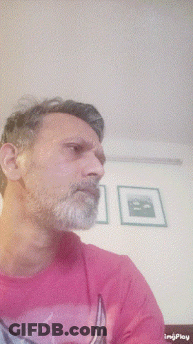 Man With Beard In Pink Shirt With Boat GIF