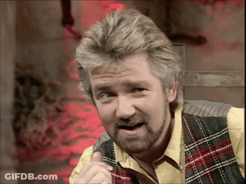 Man With Beard In Plaid Vest And Yellow Shirt GIF