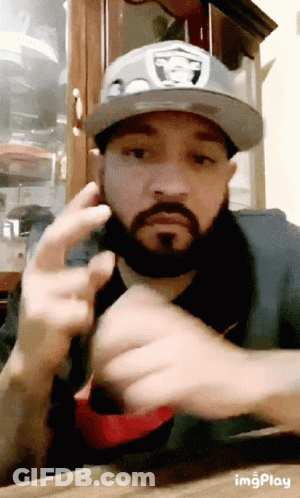 Man With Beard In Raiders Hat Flipping Off GIF