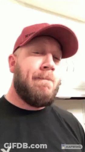 Man With Beard In Red Hat And Black Shirt GIF