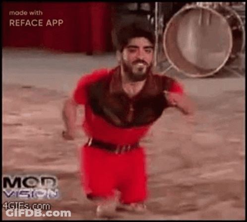 Man With Beard In Red Shirt And Shorts Dancing At Drums GIF
