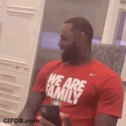 Man With Beard In Red Shirt Saying We Are Family Holding Cell Phone GIF