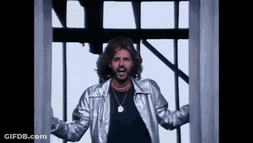 Man With Beard In Silver Jacket And Necklace GIF