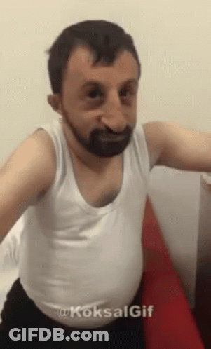 Man With Beard In White Tank Top And Black Underwear GIF