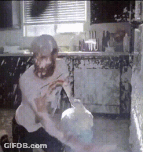 Man With Beard Kneeling In Kitchen GIF
