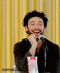 Man With Beard Laughing At Microphone GIF