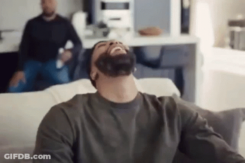 Man With Beard Laughing On Couch GIF