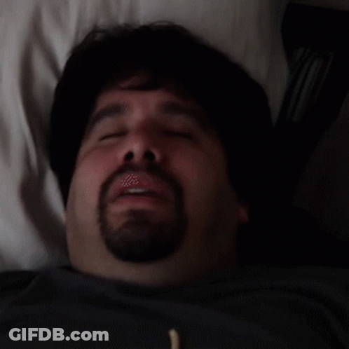 Man With Beard Laying In Bed Eyes Closed Mouth Open GIF