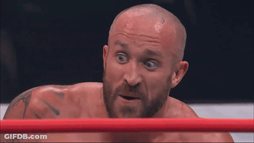 Man With Beard Laying In Boxing Ring Mouth Open GIF