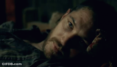 Man With Beard Laying On Bed In Dark GIF