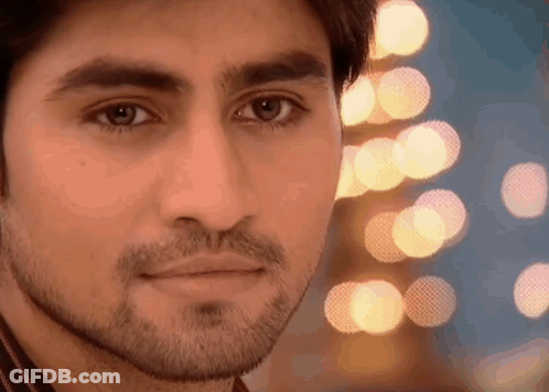 Man With Beard Looking At Camera Blurry Lights GIF