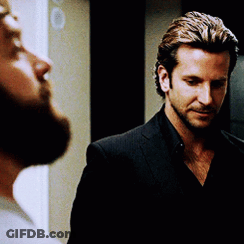 Man With Beard Looking At Man In Black Suit GIF