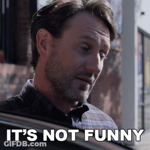 Man With Beard Looking Out Car Window Says It's Not Funny GIF