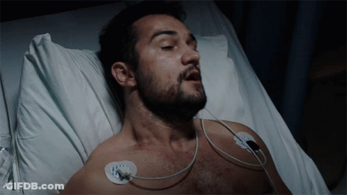 Man With Beard Lying In Hospital Bed Eyes Closed GIF