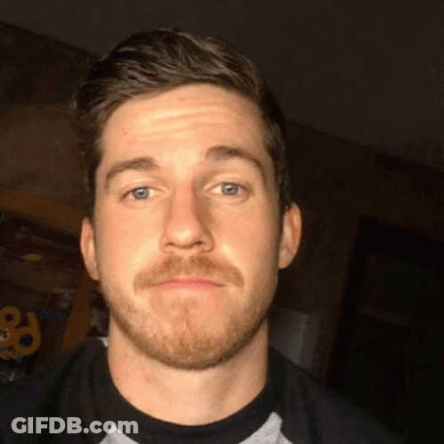 Man With Beard Making Funny Face In Dark Room GIF
