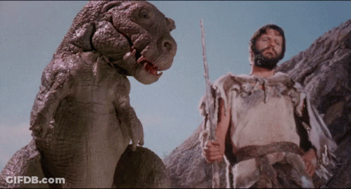 Man With Beard Next To Dinosaur With Open Mouth GIF