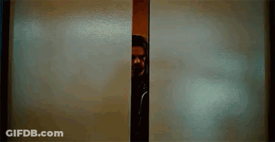 Man With Beard Peeking Out Of Doorway GIF
