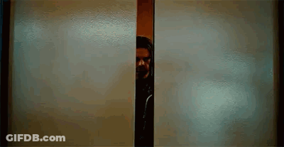Man With Beard Peeking Out Of Doorway GIF