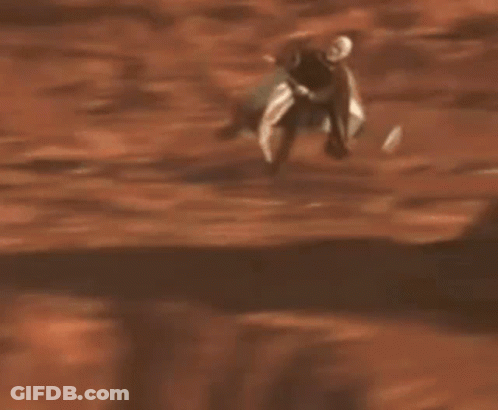 Man With Beard Riding Scooter In Sand GIF
