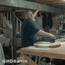 Man With Beard Sanding Wood GIF