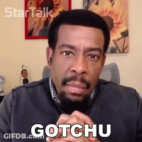 Man With Beard Saying Gotchu In Front Of Sunflower GIF