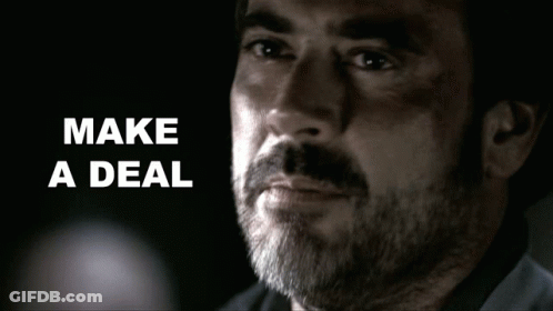 Man With Beard Says Make A Deal In Dark Room GIF