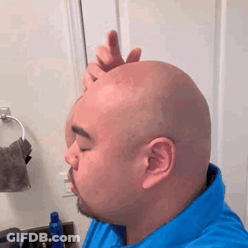 Man With Beard Shaving Head In Bathroom Mirror GIF
