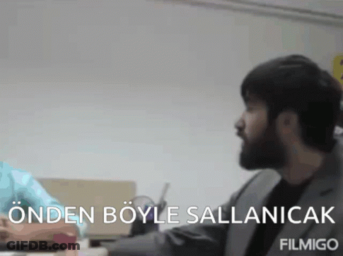 Man With Beard Sitting At Desk Saying Ondan Boyle Salanicak GIF