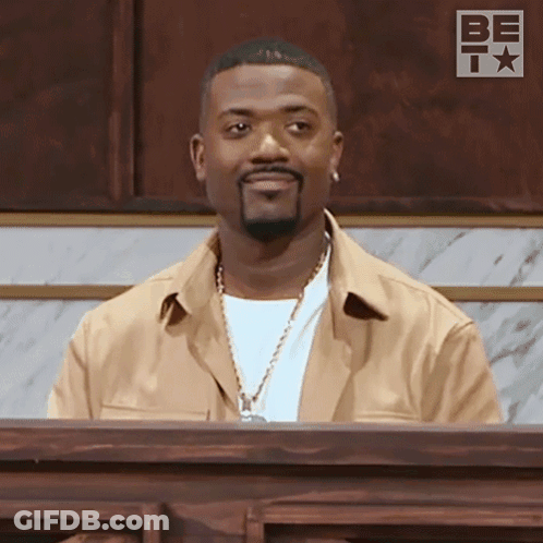 Man With Beard Sitting At Podium Saying Be GIF