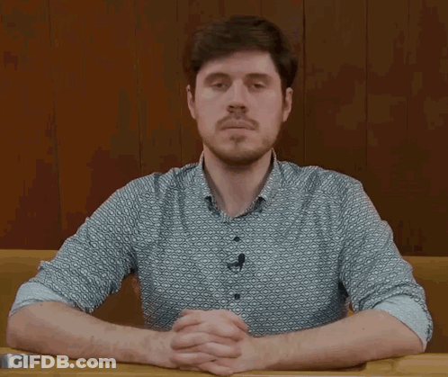 Man With Beard Sitting At Table GIF