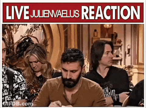 Man With Beard Sitting At Table In Front Of Live Juliewaeus Reaction Sign GIF