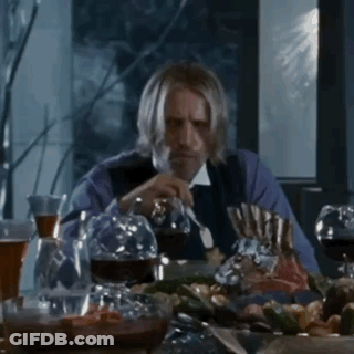 Man With Beard Sitting At Table With Wine Glasses GIF