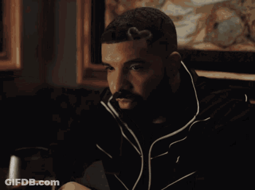 Man With Beard Sitting At Table With Wine GIF