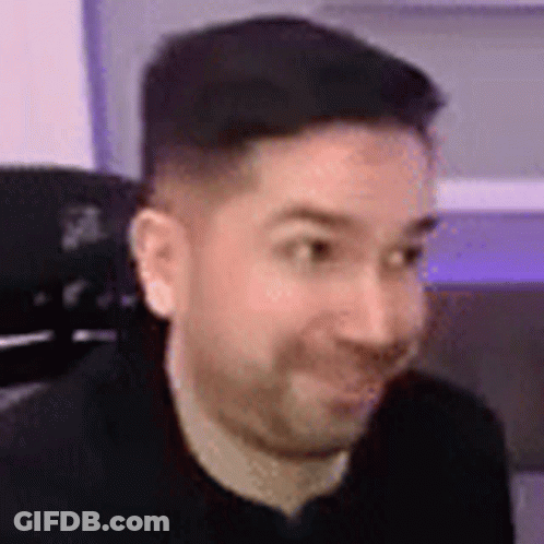 Man With Beard Sitting In Chair Smiling GIF