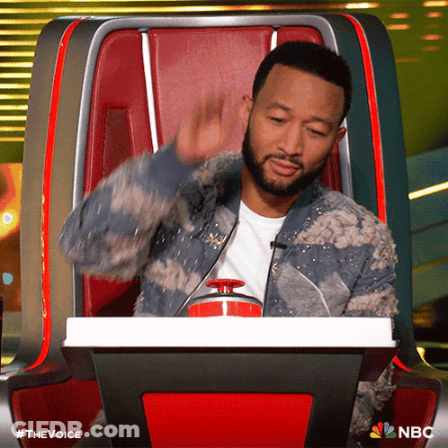 Man With Beard Sitting In Chair With NBC Logo GIF