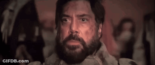 Man With Beard Sitting In Dark Room Saying Baba Booey GIF