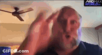 Man With Beard Sitting In Front Of Ceiling Fan GIF