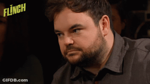 Man With Beard Sitting In Front Of Flinched Logo GIF