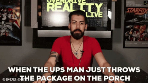 Man With Beard Sitting In Front Of Overdrive Reality Live Sign GIF