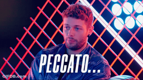 Man With Beard Sitting In Front Of Peccato Fence GIF