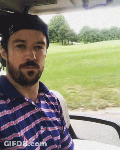 Man With Beard Sitting In Golf Cart Looking At Camera GIF