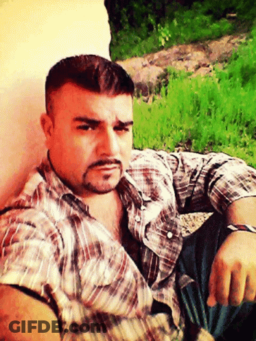 Man With Beard Sitting In Grass GIF