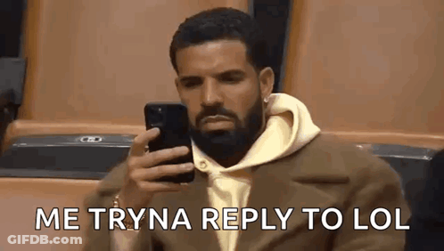 Man With Beard Sitting In Stadium Looking At Phone GIF