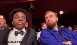 Man With Beard Sitting Next To Man In Blue Jacket GIF